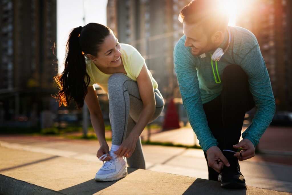 Runners tying running shoes and getting ready to run